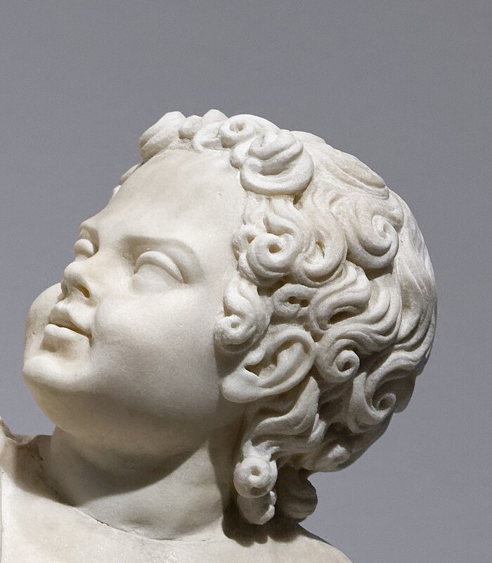 Detail of a marble statue of Britannicus as a child, from the same Louvre statue group as his mother Messalina
