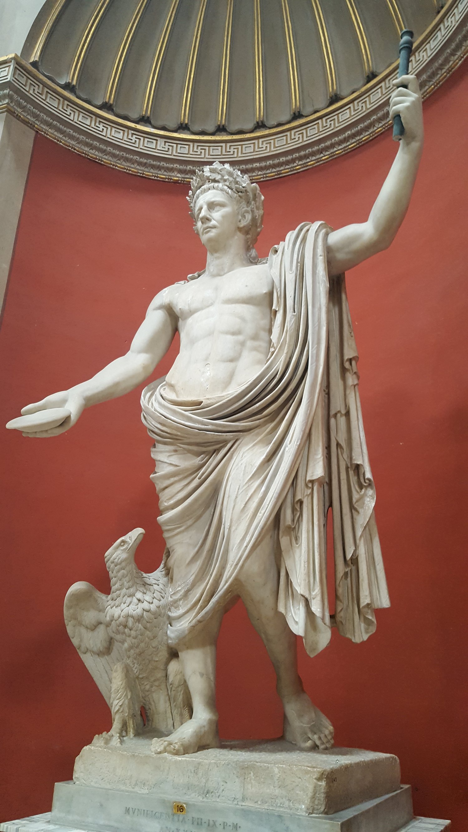 Colossal marble statue of the emperor Claudius portrayed as Jupiter, with civic crown, sceptre, and an eagle at his feet